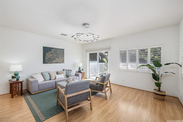 2897 Kalawao St Unit 61, Honolulu, HI 96822 - living area featuring a chandelier and light wood-style flooring