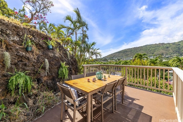 view of patio with outdoor dining area and a mountain view