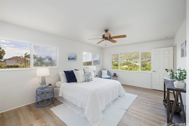 bedroom with light wood finished floors and ceiling fan