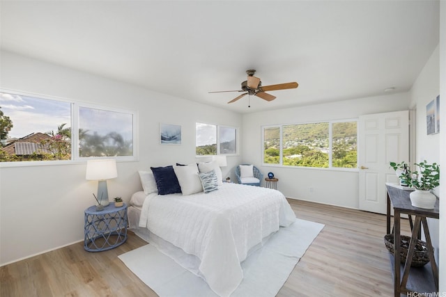 2897 Kalawao St Unit 61, Honolulu, HI 96822 - bedroom with light wood-style floors and ceiling fan