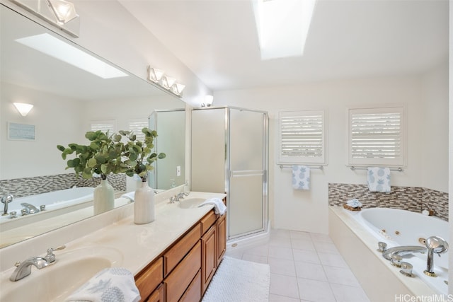 full bathroom featuring double vanity, a stall shower, a whirlpool tub, a sink, and tile patterned flooring