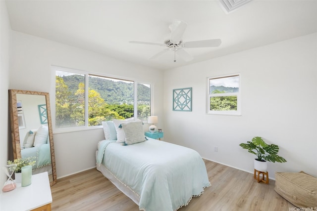 2897 Kalawao St Unit 61, Honolulu, HI 96822 - bedroom featuring light wood-type flooring and ceiling fan