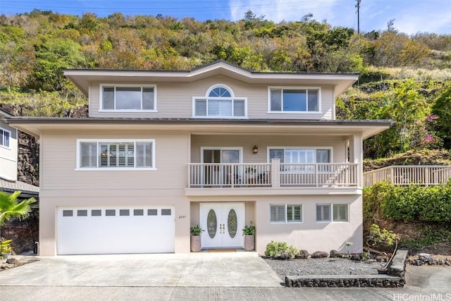 view of front of property with a garage and concrete driveway