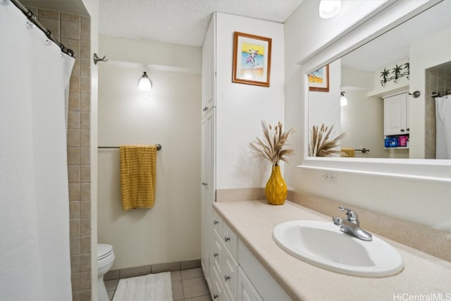 bathroom featuring curtained shower, a textured ceiling, toilet, tile patterned floors, and vanity