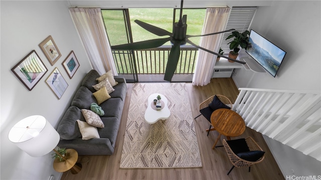 living room with wood-type flooring and a wall mounted air conditioner