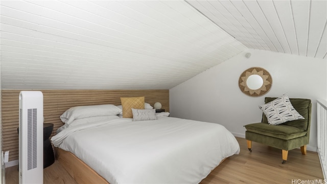 bedroom featuring vaulted ceiling and light hardwood / wood-style floors