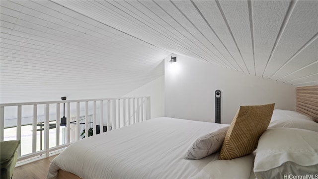 bedroom featuring wood-type flooring, vaulted ceiling, and wooden ceiling