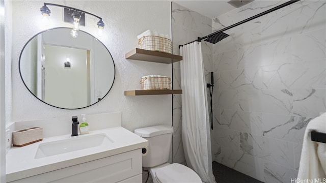 bathroom featuring toilet, curtained shower, and vanity