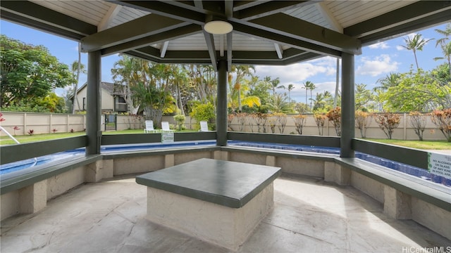 unfurnished sunroom with a healthy amount of sunlight and beamed ceiling