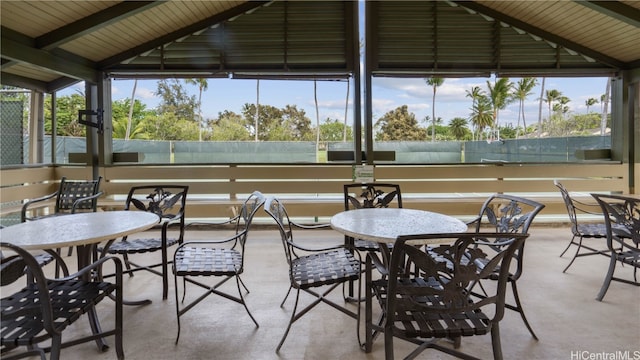 sunroom featuring vaulted ceiling with beams and wooden ceiling