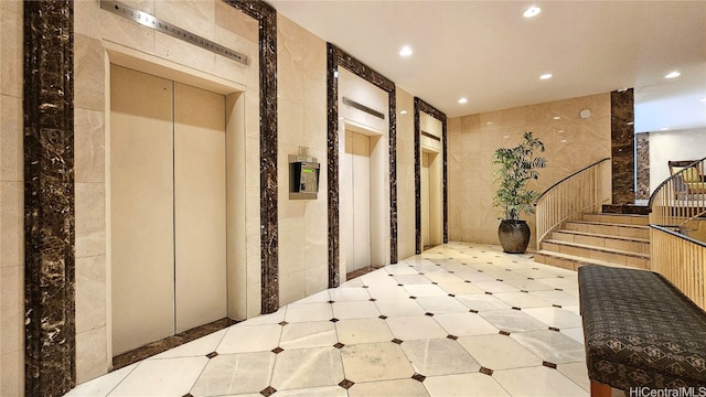 corridor featuring tile walls and elevator