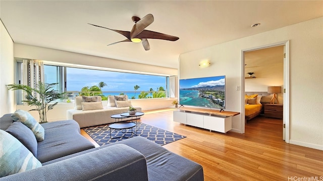 living room featuring hardwood / wood-style floors and ceiling fan