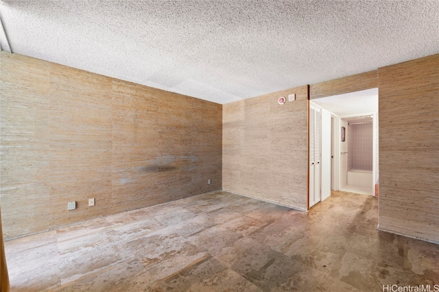 spare room featuring a textured ceiling