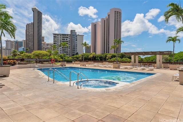 view of swimming pool featuring a pergola, a hot tub, and a patio area