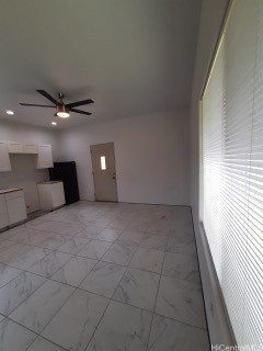 unfurnished living room with ceiling fan