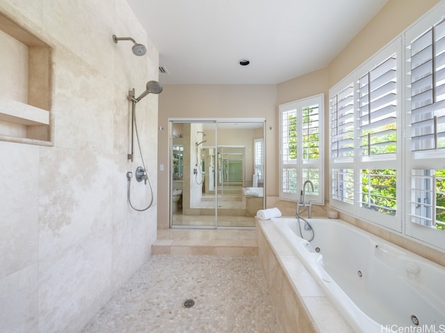 bathroom featuring toilet, independent shower and bath, and tile patterned flooring