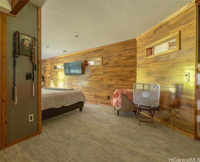 bedroom featuring wood-type flooring and wooden walls