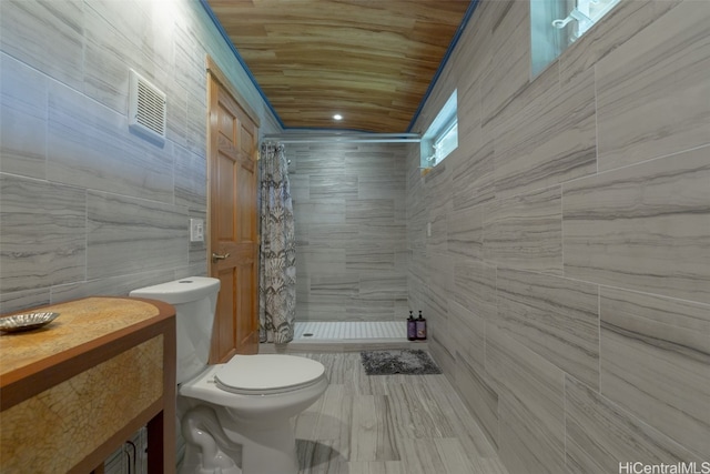 bathroom featuring vanity, tile walls, a shower with curtain, and toilet