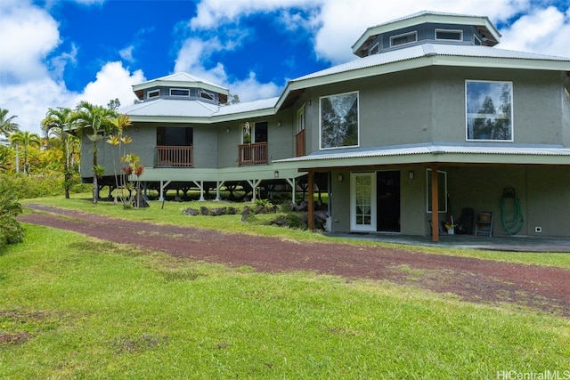 rear view of property with a yard