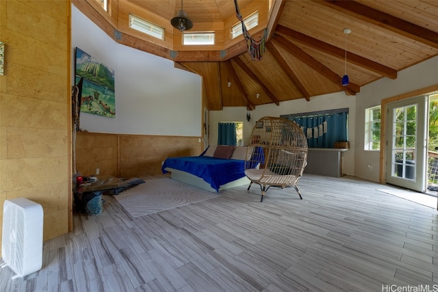 bedroom with beam ceiling, light hardwood / wood-style flooring, and wooden ceiling