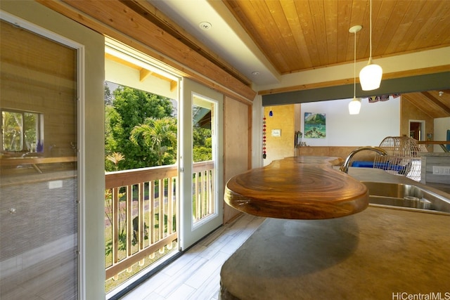 interior space with wood ceiling, light hardwood / wood-style floors, sink, and plenty of natural light