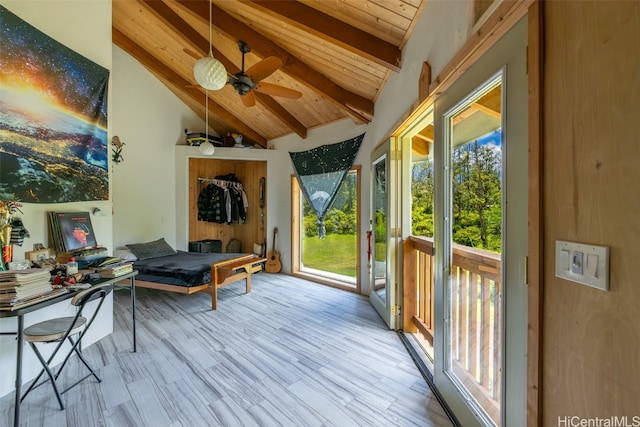 sunroom featuring wood ceiling, lofted ceiling with beams, and ceiling fan