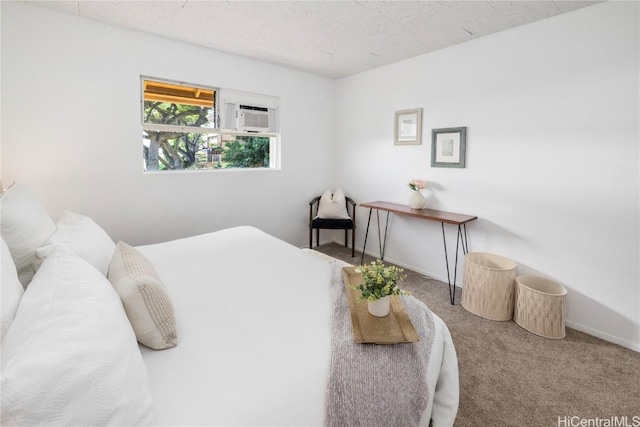 bedroom with carpet flooring, a textured ceiling, and a wall mounted AC