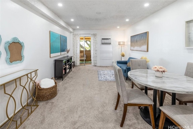 carpeted dining room featuring a textured ceiling