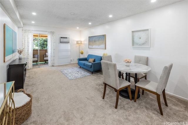 carpeted dining space with a textured ceiling