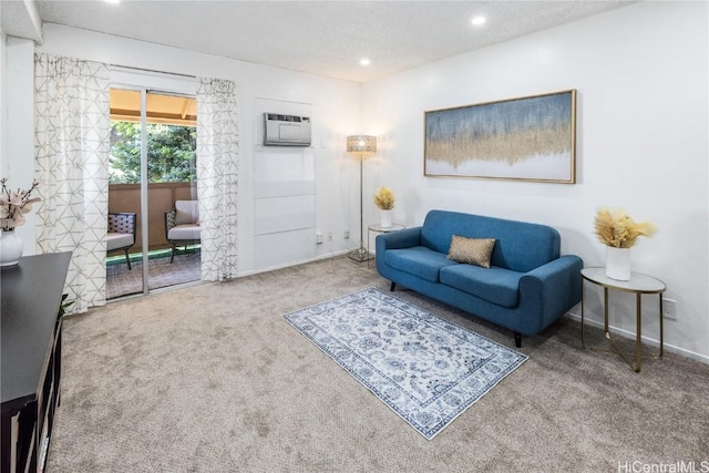 living room with an AC wall unit and carpet floors