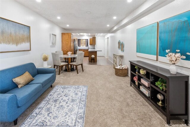 living room featuring a textured ceiling and light carpet