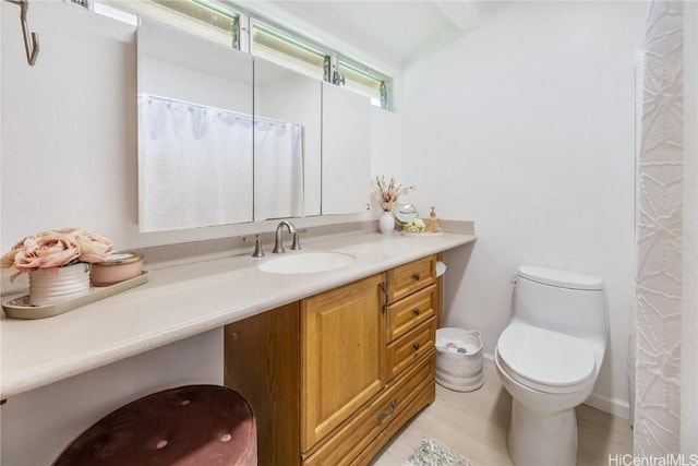 bathroom with hardwood / wood-style floors, vanity, and toilet