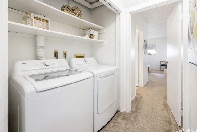 clothes washing area featuring separate washer and dryer, light carpet, and a textured ceiling