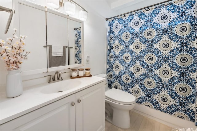 bathroom featuring hardwood / wood-style flooring, vanity, toilet, and a shower with curtain