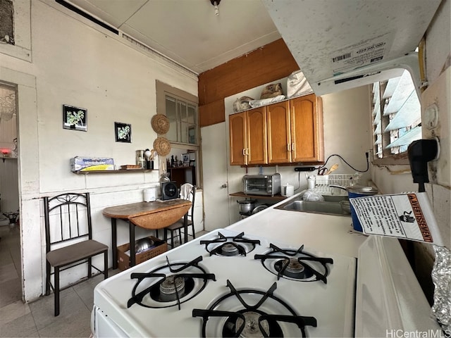 kitchen with white range with gas stovetop and sink