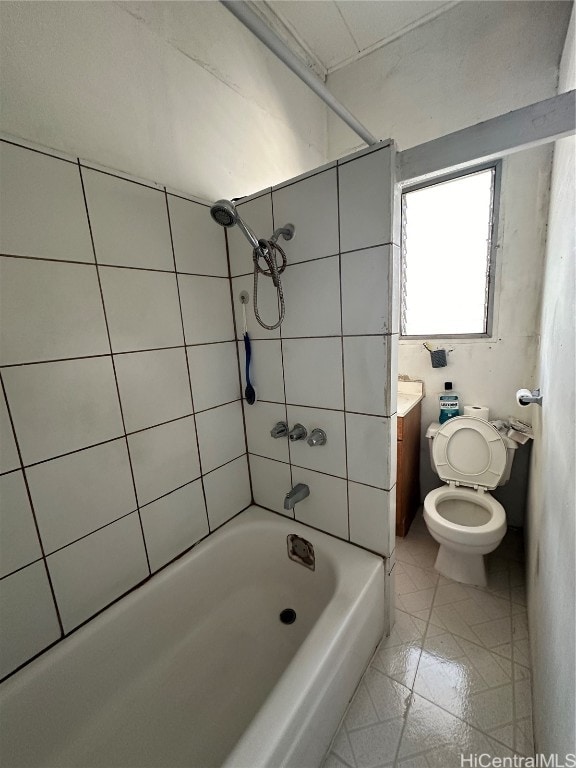 full bathroom featuring toilet, tiled shower / bath combo, vanity, and tile patterned floors