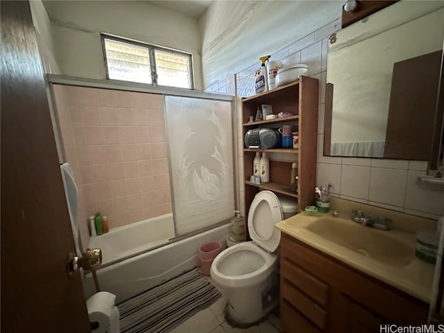 full bathroom featuring decorative backsplash, toilet, tile patterned flooring, vanity, and shower / bath combination with glass door