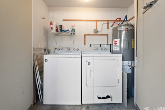 washroom featuring water heater and washing machine and dryer