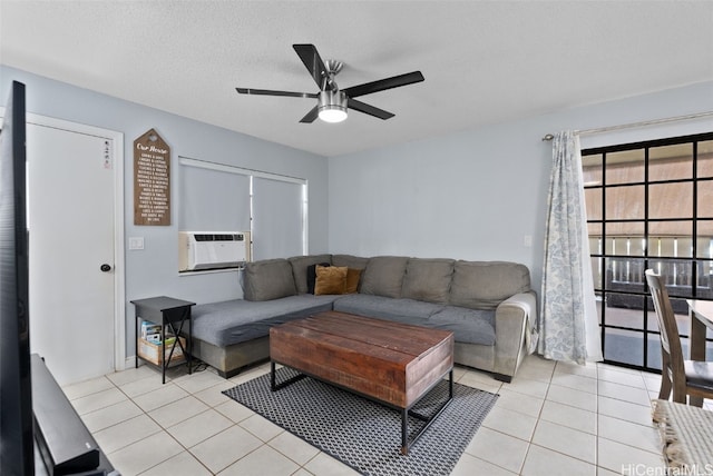 living room with ceiling fan, a textured ceiling, cooling unit, and light tile patterned flooring