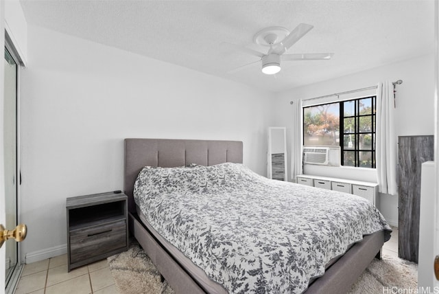 tiled bedroom featuring a closet, ceiling fan, a textured ceiling, and cooling unit