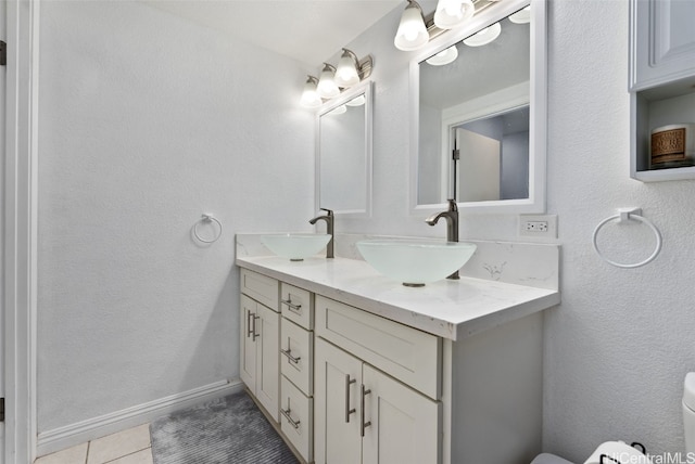 bathroom featuring vanity, toilet, and tile patterned floors