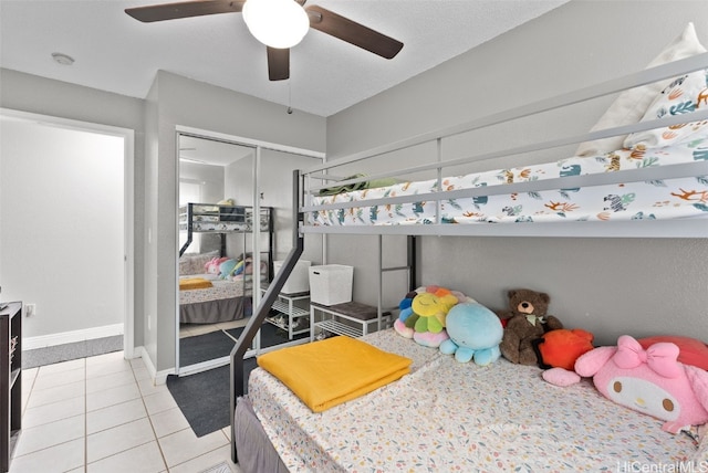 tiled bedroom with a closet and ceiling fan