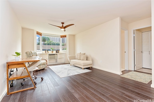 living area featuring dark wood-type flooring, ceiling fan, and a wall mounted AC