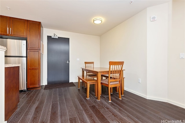 dining space featuring dark wood-type flooring