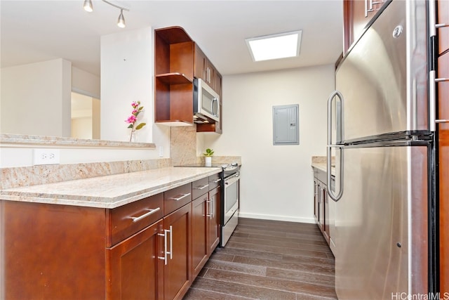 kitchen with appliances with stainless steel finishes, dark hardwood / wood-style floors, electric panel, and light stone countertops