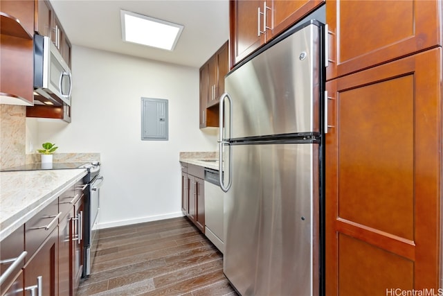 kitchen featuring backsplash, light stone countertops, electric panel, appliances with stainless steel finishes, and dark hardwood / wood-style flooring