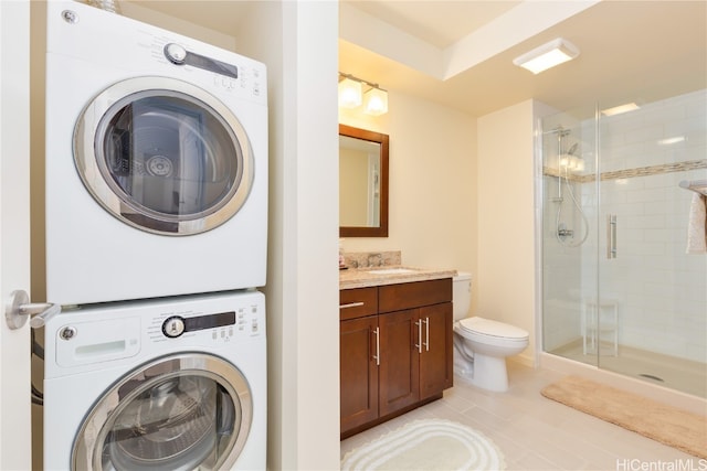 laundry room featuring stacked washer / drying machine, sink, and light tile patterned floors