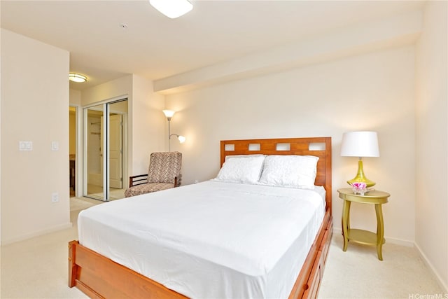bedroom featuring light colored carpet, a closet, and baseboards