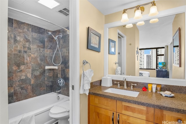 full bathroom with vanity, toilet, and tiled shower / bath combo