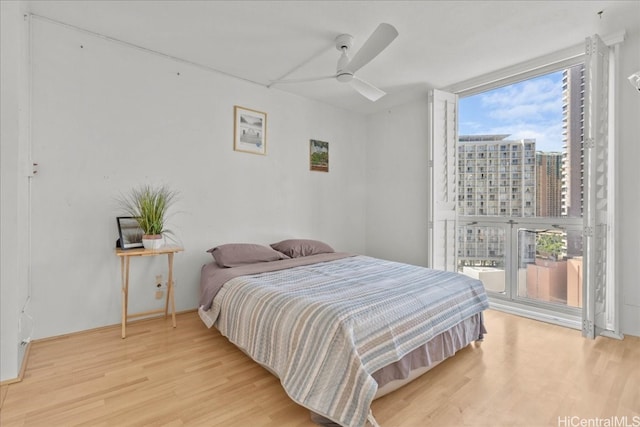 bedroom featuring wood-type flooring and ceiling fan